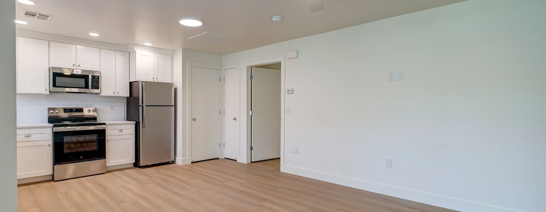 a kitchen with white cabinets