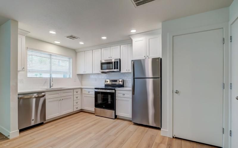 a kitchen with white cabinets