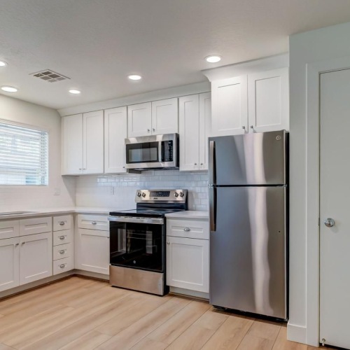 a kitchen with white cabinets